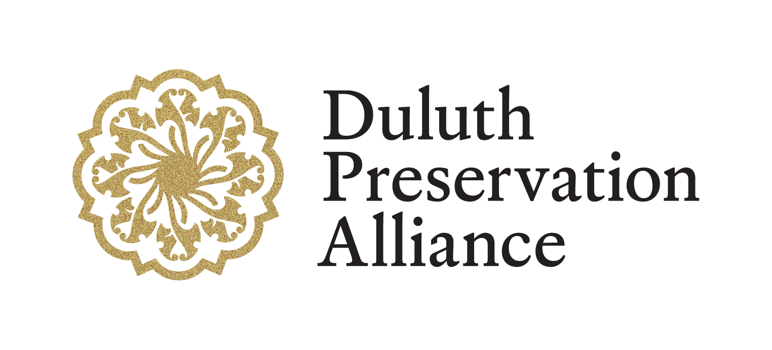 Logo of the Duluth Preservation Alliance featuring a gold ornamental floral design on the left and the organization's name in black serif font on the right.