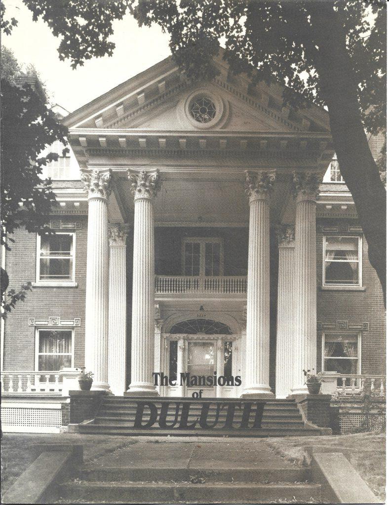 A large, ornate mansion with tall white columns and a triangular pediment, framed by trees. The text "The Mansions of DULUTH" appears at the bottom of the image.