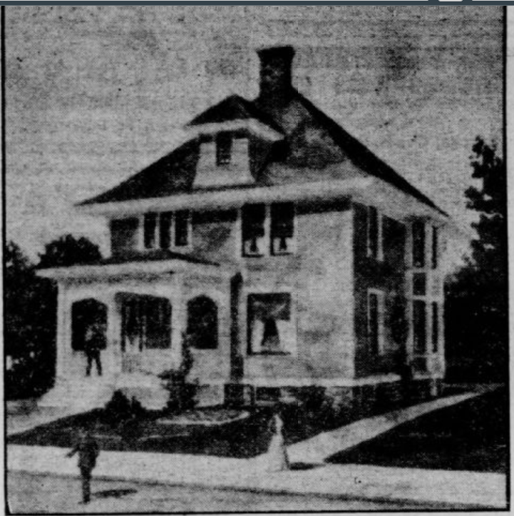A black and white vintage photograph of a two-story house with an attic and a large front porch. Three people are visible: one stands on the porch, one is on the lawn, and another walks along the sidewalk.
